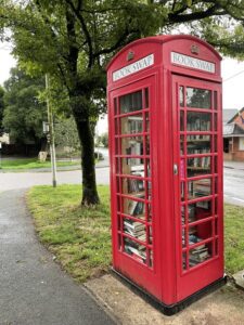 UK red telephone box converted into a Tiny Library, full of books photograph